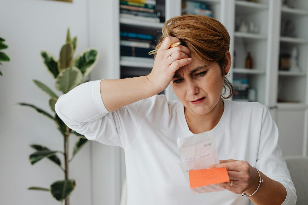 Woman with invoices, calculating overhead costs